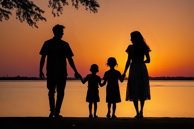 Familie bei Sonnenuntergang am Strand